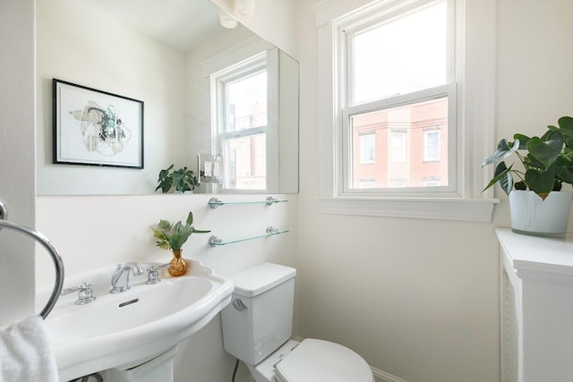 half bath with a sink and toilet