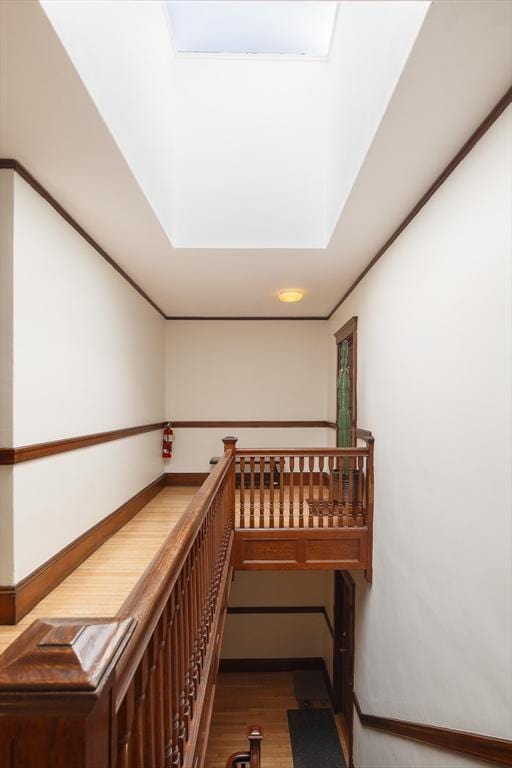 hallway featuring an upstairs landing and wood finished floors