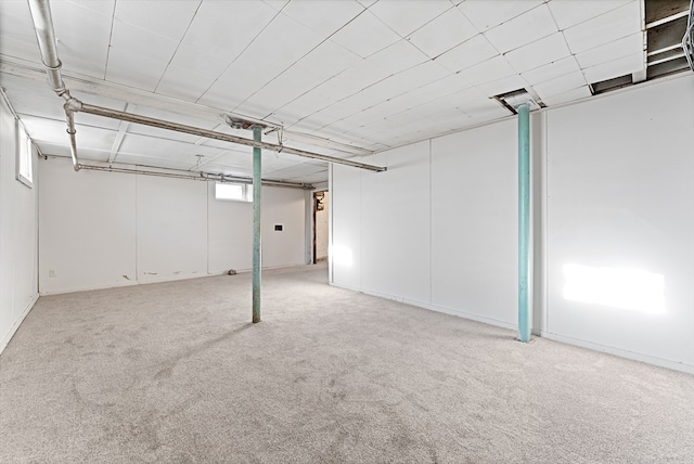 basement featuring light carpet