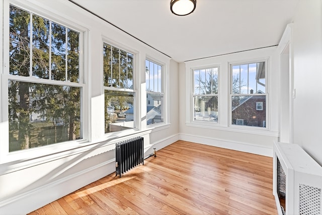 unfurnished sunroom featuring radiator