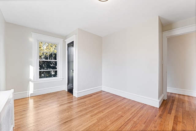 spare room with light hardwood / wood-style flooring