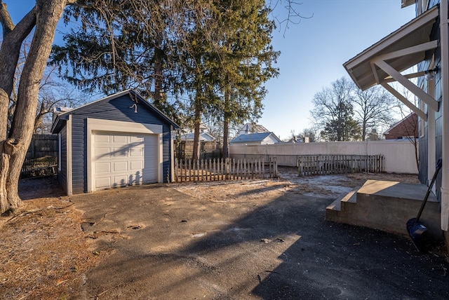 view of yard featuring a garage and an outbuilding