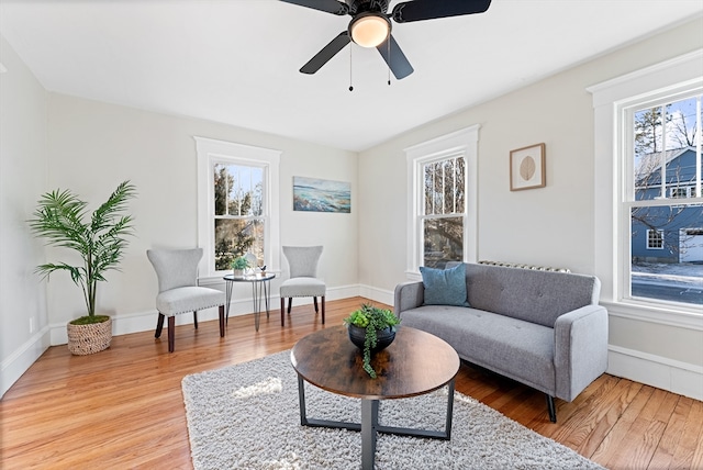 sitting room featuring ceiling fan, a healthy amount of sunlight, and hardwood / wood-style flooring