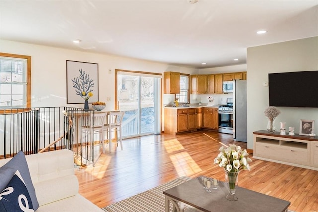 living room with sink and light hardwood / wood-style floors