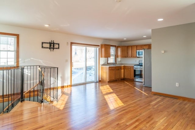 kitchen featuring sink, stainless steel appliances, and light hardwood / wood-style floors