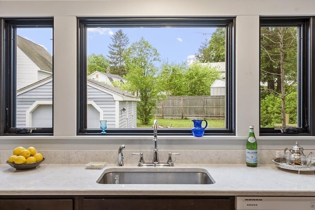 14 Thoreau St, Concord, MA 01742 - kitchen featuring a sink, dishwasher, plenty of natural light, and light stone countertops