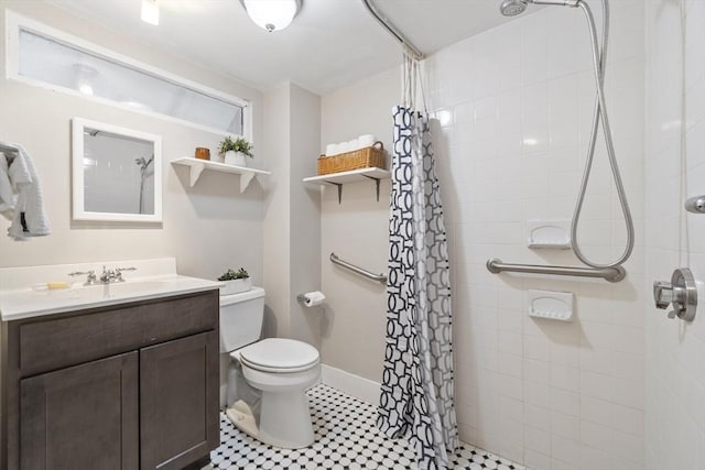 14 Thoreau St, Concord, MA 01742 - bathroom with tiled shower, vanity, toilet, and baseboards