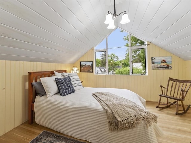 14 Thoreau St, Concord, MA 01742 - bedroom featuring vaulted ceiling, wood finished floors, wooden walls, and a chandelier