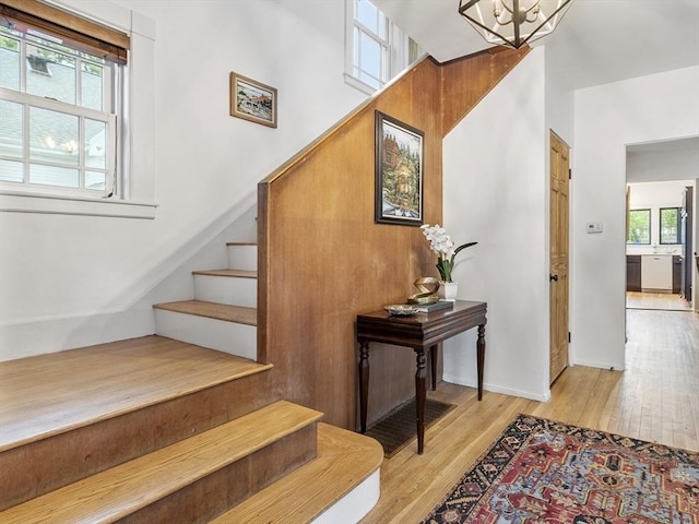 14 Thoreau St, Concord, MA 01742 - stairway with wood finished floors, a chandelier, and a towering ceiling