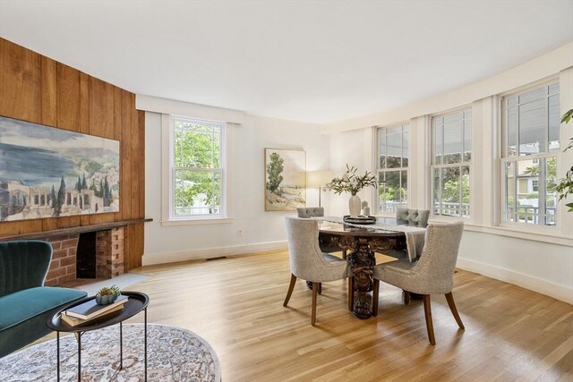 14 Thoreau St, Concord, MA 01742 - dining area with light wood-style flooring, baseboards, and a brick fireplace