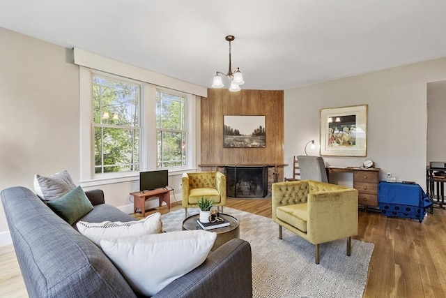 14 Thoreau St, Concord, MA 01742 - living room featuring wood finished floors, a chandelier, and a fireplace