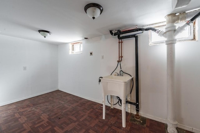 basement featuring dark parquet flooring