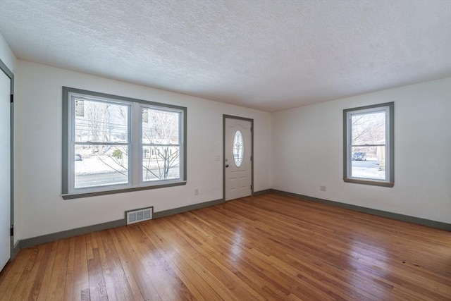 entryway featuring hardwood / wood-style flooring and a textured ceiling