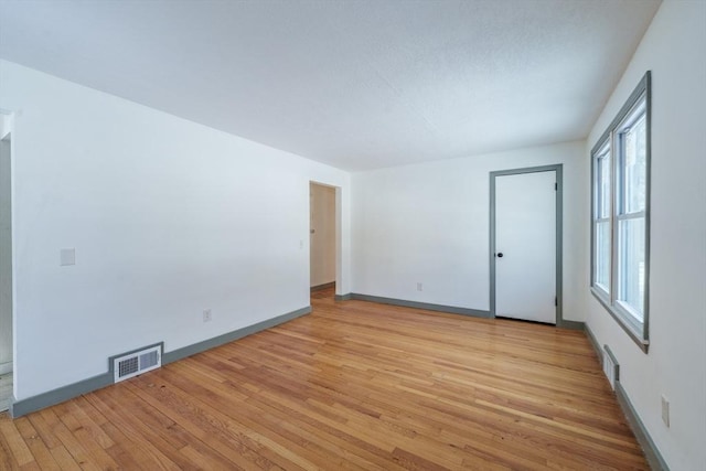 spare room with light hardwood / wood-style flooring