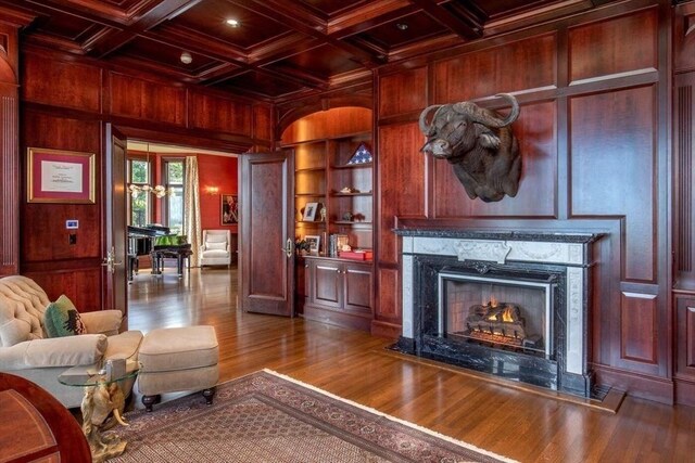 dining area featuring decorative columns, a raised ceiling, crown molding, and a chandelier