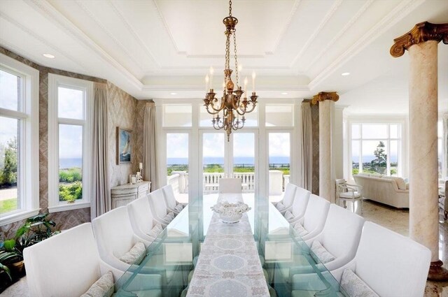 bedroom with a water view, a chandelier, dark hardwood / wood-style flooring, and vaulted ceiling