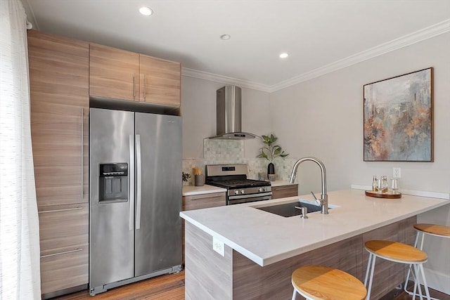 24 Lemon St Unit 2, Salem, MA 01970 - kitchen with appliances with stainless steel finishes, wall chimney range hood, a kitchen bar, ornamental molding, and a peninsula