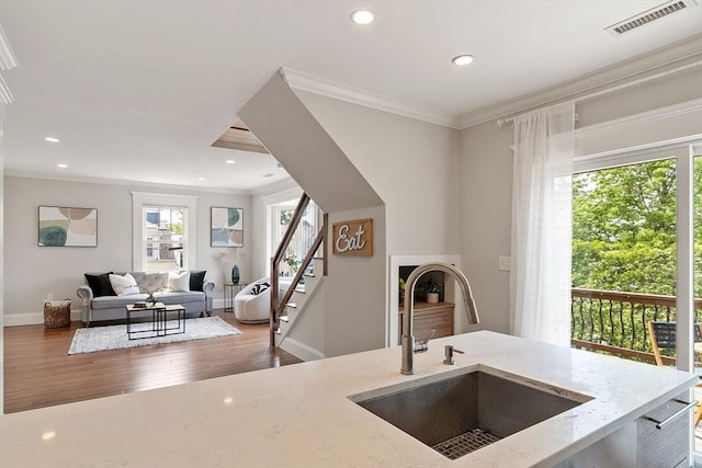 24 Lemon St Unit 2, Salem, MA 01970 - kitchen featuring crown molding, plenty of natural light, light stone countertops, wood finished floors, and recessed lighting