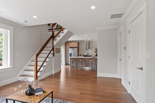 24 Lemon St Unit 2, Salem, MA 01970 - living room with stairs, crown molding, wood finished floors, and recessed lighting