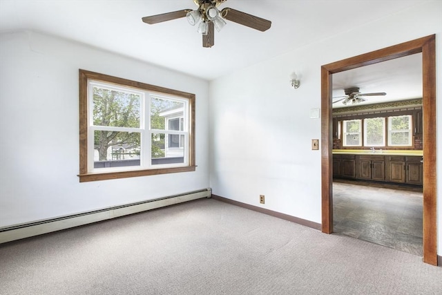 10 Hazel Plz, Uxbridge, MA 01569 - spare room featuring a baseboard heating unit, a ceiling fan, light colored carpet, baseboards, and a sink