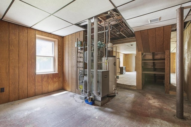 10 Hazel Plz, Uxbridge, MA 01569 - below grade area with gas water heater, wood walls, and a heating unit
