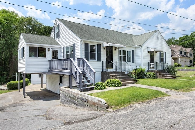 10 Hazel Plz, Uxbridge, MA 01569 - view of front of property with a shingled roof, driveway, a carport, and a front lawn
