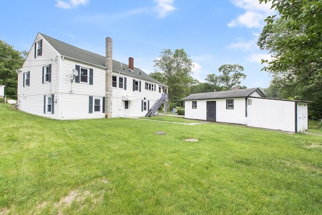10 Hazel Plz, Uxbridge, MA 01569 - rear view of house with a chimney, a yard, and stairs