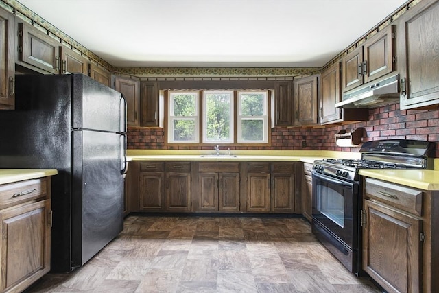 10 Hazel Plz, Uxbridge, MA 01569 - kitchen featuring black appliances, under cabinet range hood, a sink, light countertops, and decorative backsplash