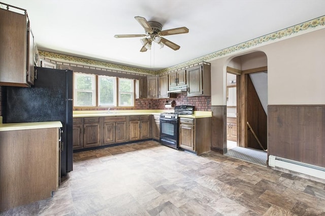 10 Hazel Plz, Uxbridge, MA 01569 - kitchen with black appliances, under cabinet range hood, a wainscoted wall, ceiling fan, and light countertops