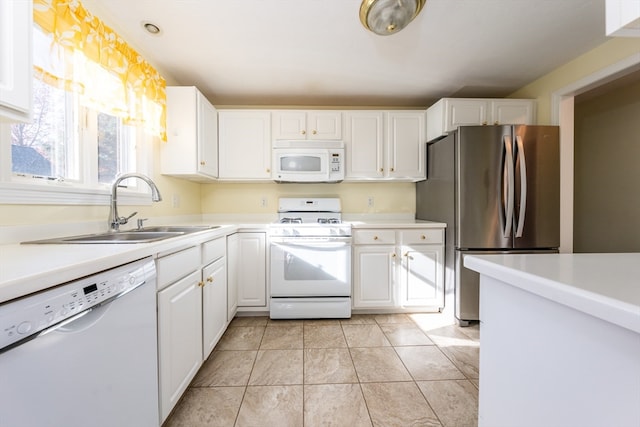 kitchen featuring light countertops, light tile patterned flooring, a sink, white cabinets, and white appliances