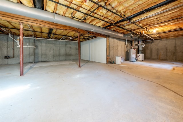 unfinished basement featuring gas water heater