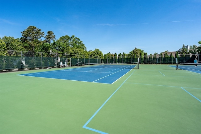 view of tennis court with fence