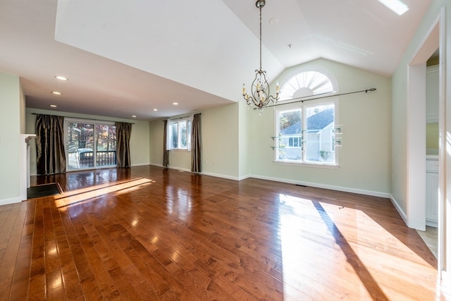 interior space featuring recessed lighting, a notable chandelier, wood finished floors, baseboards, and vaulted ceiling