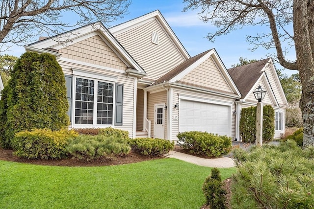 view of front facade featuring an attached garage and a front lawn