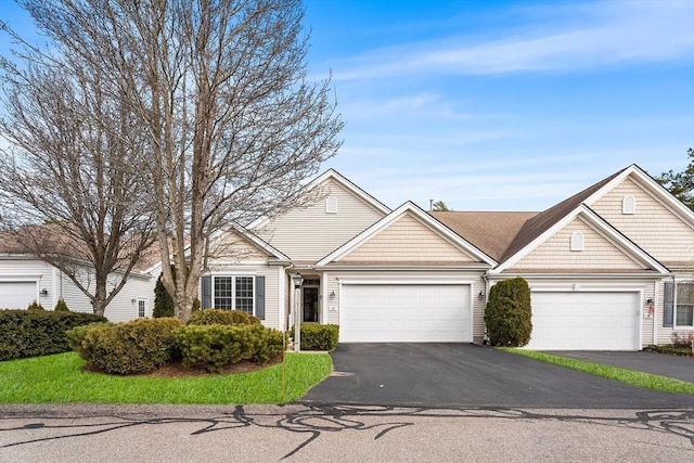 ranch-style house featuring an attached garage and driveway