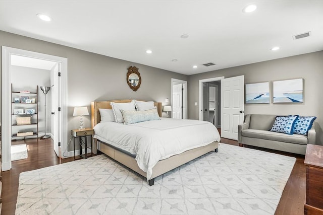 bedroom featuring wood finished floors, recessed lighting, and baseboards