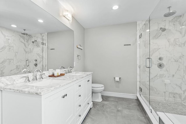 bathroom with marble finish flooring, a marble finish shower, recessed lighting, baseboards, and double vanity