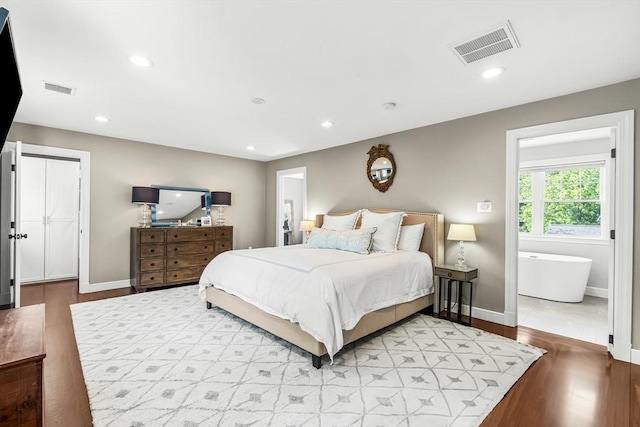 bedroom with light wood-type flooring, baseboards, and recessed lighting