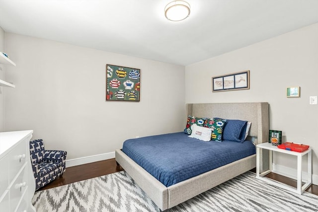 bedroom featuring wood finished floors and baseboards