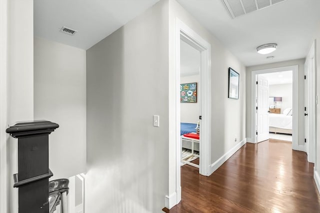hallway with wood finished floors and baseboards
