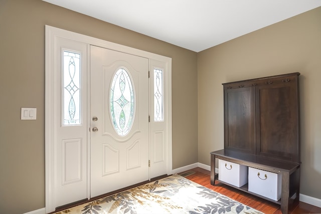 foyer entrance with dark hardwood / wood-style floors