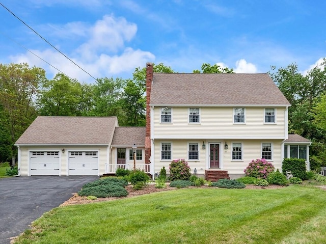 58 Fitzpatrick Rd, Grafton, MA 01519 - colonial-style house featuring a chimney, asphalt driveway, a garage, and a front yard