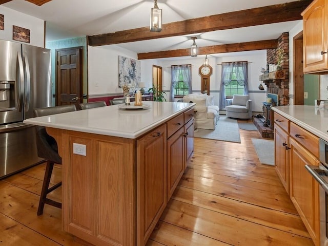 58 Fitzpatrick Rd, Grafton, MA 01519 - kitchen with stainless steel refrigerator with ice dispenser, light wood-style flooring, open floor plan, a breakfast bar area, and beam ceiling