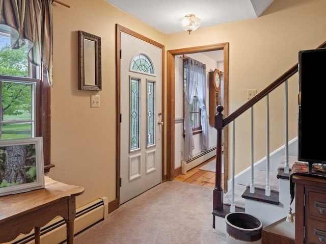 58 Fitzpatrick Rd, Grafton, MA 01519 - entryway with a baseboard heating unit, stairs, and light colored carpet