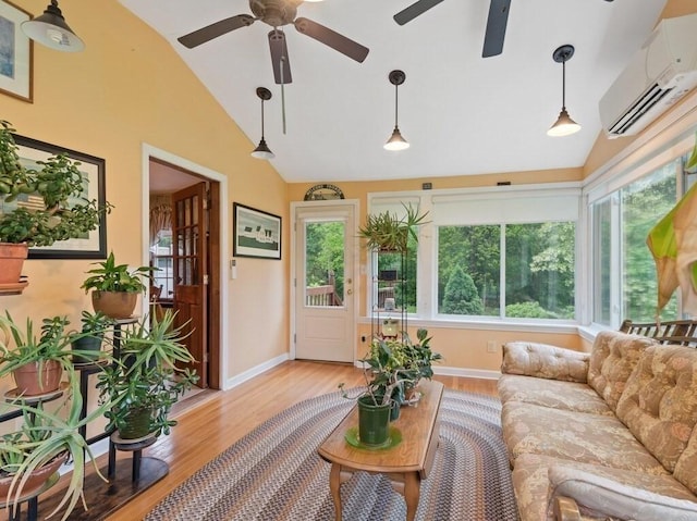 58 Fitzpatrick Rd, Grafton, MA 01519 - living area featuring vaulted ceiling, an AC wall unit, a ceiling fan, light wood-style flooring, and baseboards