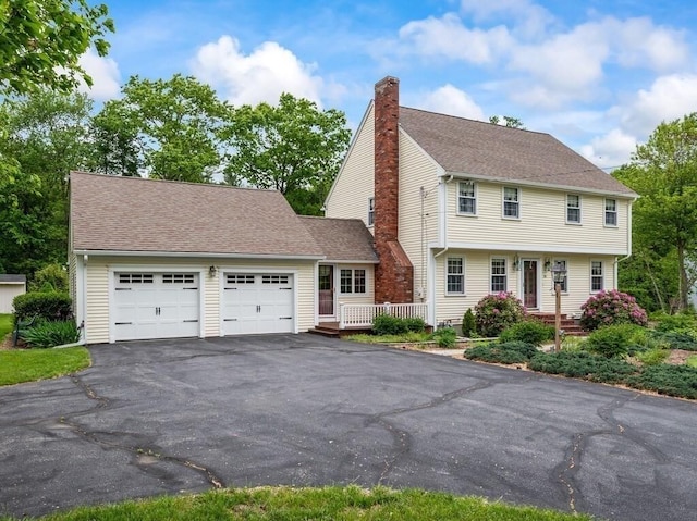 58 Fitzpatrick Rd, Grafton, MA 01519 - colonial home with a chimney, an attached garage, driveway, and roof with shingles