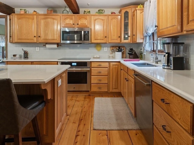 58 Fitzpatrick Rd, Grafton, MA 01519 - kitchen with stainless steel appliances, a sink, light countertops, backsplash, and beam ceiling