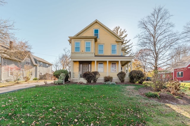 view of front of house with a front yard and a porch