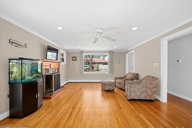 living area featuring recessed lighting, baseboards, a fireplace, light wood-style flooring, and baseboard heating