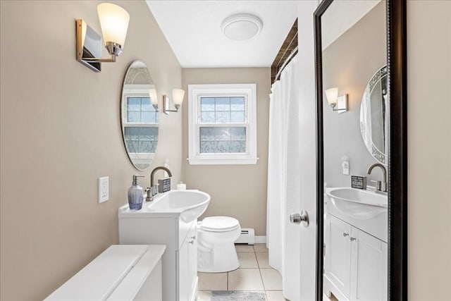full bathroom featuring tile patterned flooring, toilet, a sink, baseboards, and baseboard heating